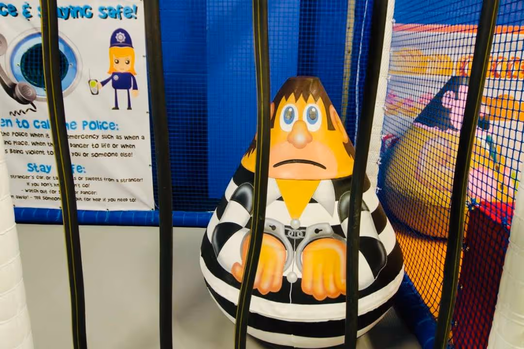 Role play police station jail cell with escape hatch in under 5's area at Bubbles Wirral